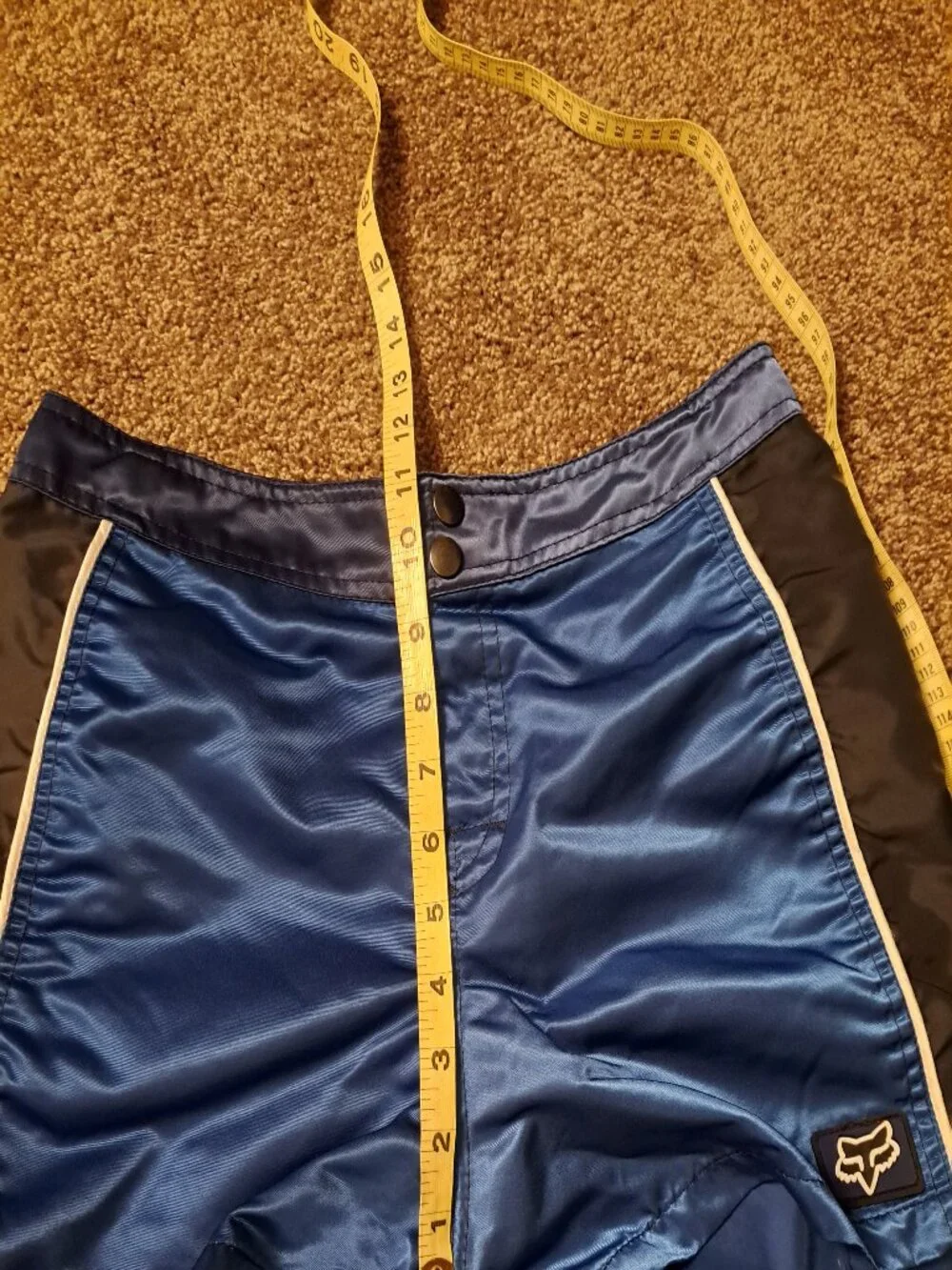 Vintage Fox Racing board shorts featuring a blue satin finish &white piping.